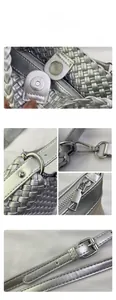 Detail of silver woven handbag showing magnetic buckle and adjustable shoulder strap hardware