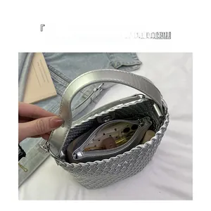 Top view of silver woven bucket bag showing large capacity with internal zipper pocket