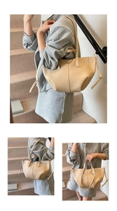 Detail of beige pebbled leather tote with curved opening and minimalist vertical stitching