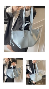 Macro shot of sky blue lychee grain leather tote with dual straps and side details