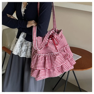 Detail of red gingham tote bag with ruffled layers and functional drawstring closure