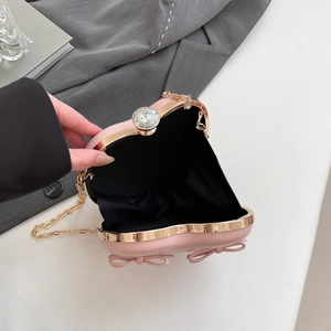 Pink heart-shaped evening clutch bag with crystal clasp and golden chain strap