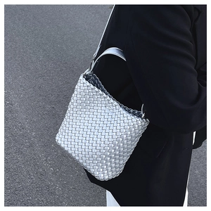 Close-up of metallic silver woven tote bag featuring high-quality braided craftsmanship
