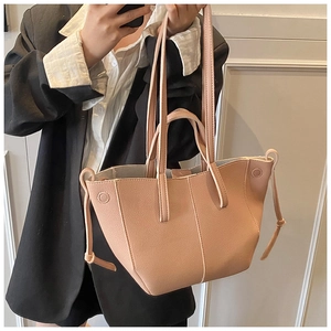 Detailansicht der rosa Ledertasche mit eleganter Lychee-Narbung und Knotenverzierung