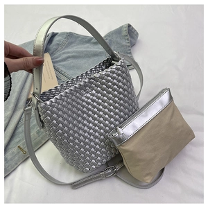 Silver woven tote bag with canvas inner pouch and adjustable shoulder strap detail