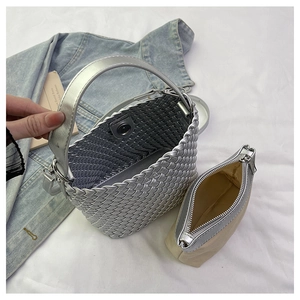 Top view of woven silver bucket bag showing the removable inner canvas pouch detail