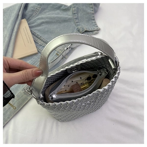 Silver woven bucket bag detail showing internal pouch with phone and cosmetics