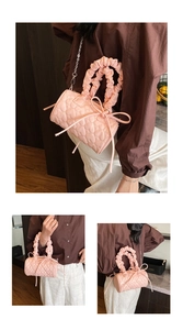 Close-up of pink heart quilted barrel bag with scrunched handle and bow detail