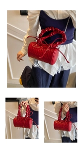 Detail of red cylindrical handbag with heart-shaped quilting and ruched cloud handle