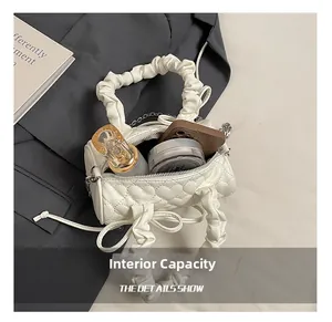 Internal capacity of the white quilted cylindrical bag showing daily essentials storage