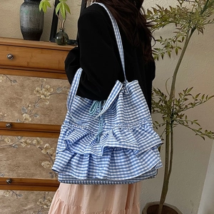 Blue and white plaid tote bag with layered ruffle details and drawstring closure