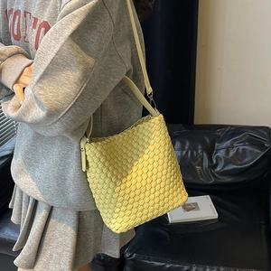 Fashionable bright yellow woven bucket shoulder bag with sleek leather strap for women