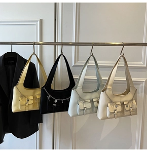 Multiple colors of faux leather shoulder bags with metal chains and heart pendants