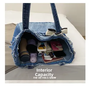 Top view of large washed denim tote bag showing interior space for umbrella and water bottle