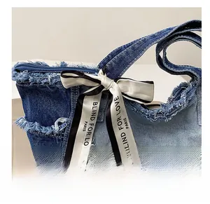 Close-up of retro denim tote bag with frayed edges and a decorative printed silk scarf