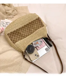 Detail view of woven straw tote bag showing spacious interior and daily essentials