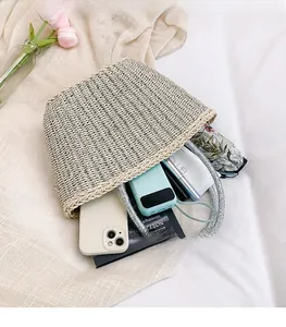 Top view of spacious woven straw bucket bag showing large interior storage and double handles