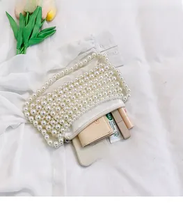 Top view of white pearl beaded handbag showing spacious interior with zipper closure