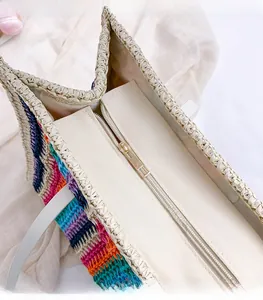 Detail of multi-color rainbow woven tote with golden zipper closure and fabric tape