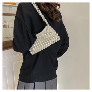 Detailed view of handmade pearl woven square bag showing intricate beadwork texture