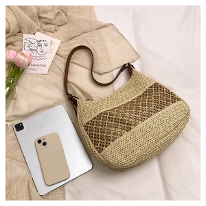 Close-up of handmade woven straw tote showing detailed beige and brown mesh texture