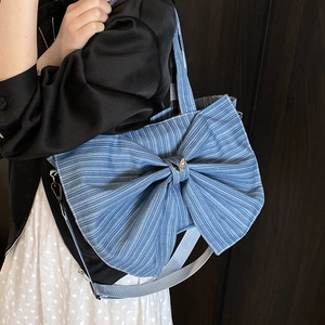 Blue corduroy tote bag featuring a large bow and gold butterfly detail for women