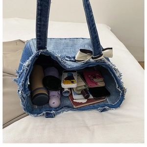 Interior detail of large denim tote bag showing spacious capacity for daily items
