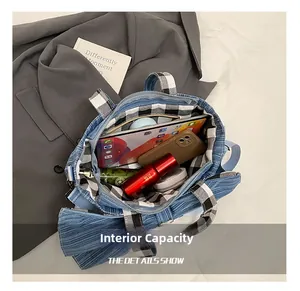 Top-down view of large capacity blue corduroy tote bag showing plaid inner lining