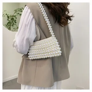 Close-up of handmade white pearl woven shoulder bag showing detailed bead texture
