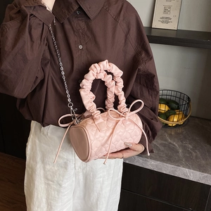 Pink heart quilted cylinder pillow bag with ruffled handles and silver chain strap