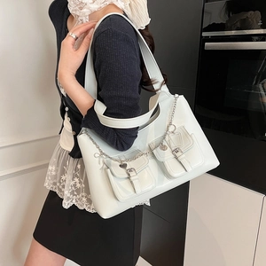Light blue faux leather shoulder bag with heart charms and double front pockets
