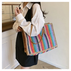Bohemian large rainbow woven straw tote bag shown on shoulder for daily commuting
