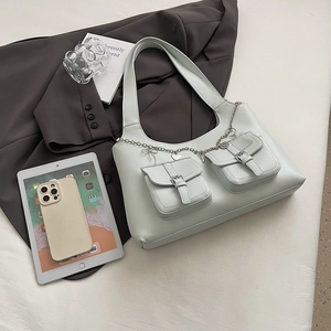 Light green leather underarm bag with decorative metal chains and front buckle pockets