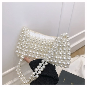 Detail of handmade beaded square bag with pearl weaving and top zipper closure