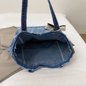 Retro denim tote bag with raw edges, large capacity, zipper closure, and bow detail