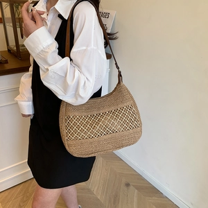 Handwoven straw shoulder bag with leather straps and beige mesh detail for beach vacation