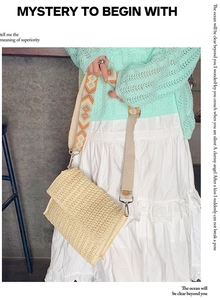 Detail of woven straw shoulder bag with a colorful ethnic geometric strap and top flap