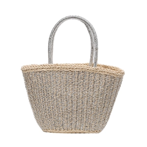Handwoven straw tote bag with silver metallic accents and dual handles for summer beach resort
