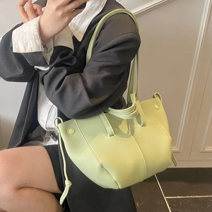 Chic lime green minimalist leather shoulder bag with unique side drawstring detail