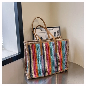 Detailed view of colorful striped woven texture and brown leather straps on large tote bag