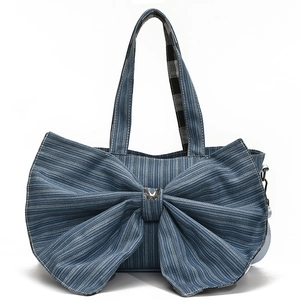Blue striped canvas tote bag with a large bow decoration and silver butterfly buckle