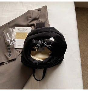 Close-up of the black quilted tote bag interior showing the inner lining and logo label