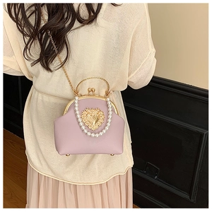 Detail of lavender litchi grain leather bag with heart relief and pearl handle