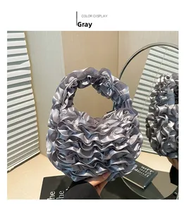Detailed view of grey ruffled lace handbag with shimmering satin texture for evening