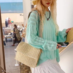 Straw shoulder bag with ethnic geometric strap and mint green crochet knit top