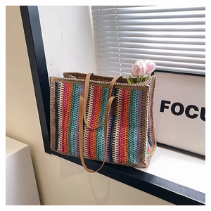 Detail of colorful striped crochet weave texture and brown faux leather handles of a tote bag