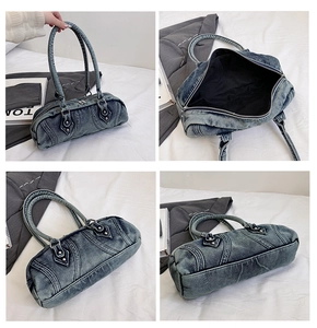 Detail view of retro washed denim cylinder bag showing stitching and metal rivets details