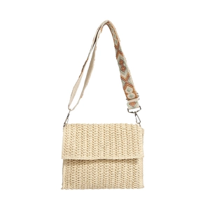 Minimalist straw crossbody bag with vintage geometric strap on white background