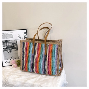Detail of colorful striped hand-woven tote bag with brown leather handles and cotton lining