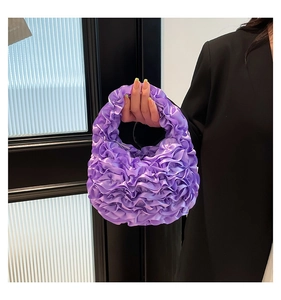 Detail of purple pleated tulle handbag with satin finish and ruffle texture handheld view